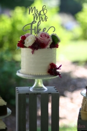 Horizontal-textured-buttercream-Mr-and-Mrs-Fitch-cutting-cake